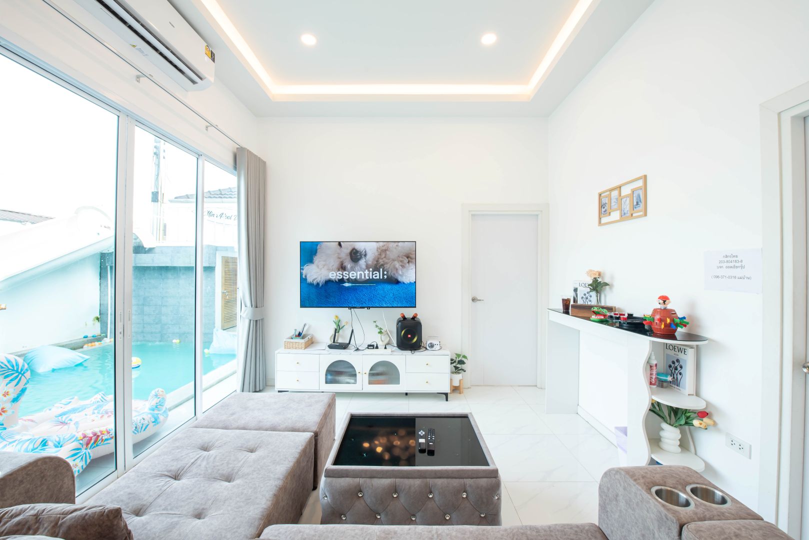 Living room with pool view at Mina Pool Villa