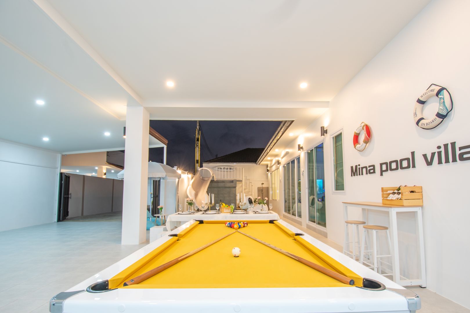 Pool table and outdoor area at night at Mina Pool Villa