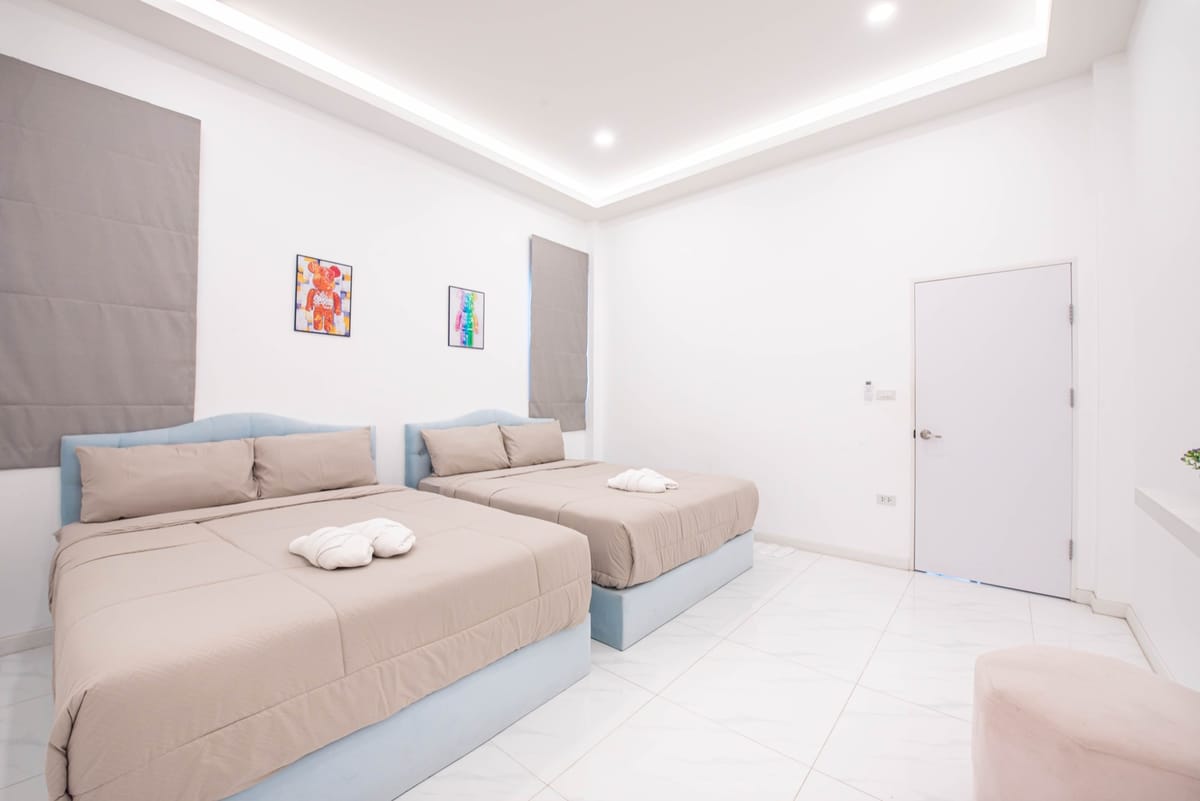Blue bedroom with two large beds