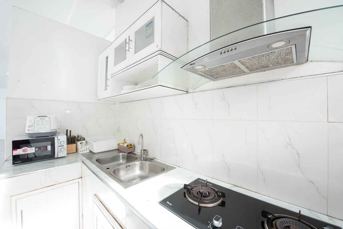 Kitchen with gas stove and range hood