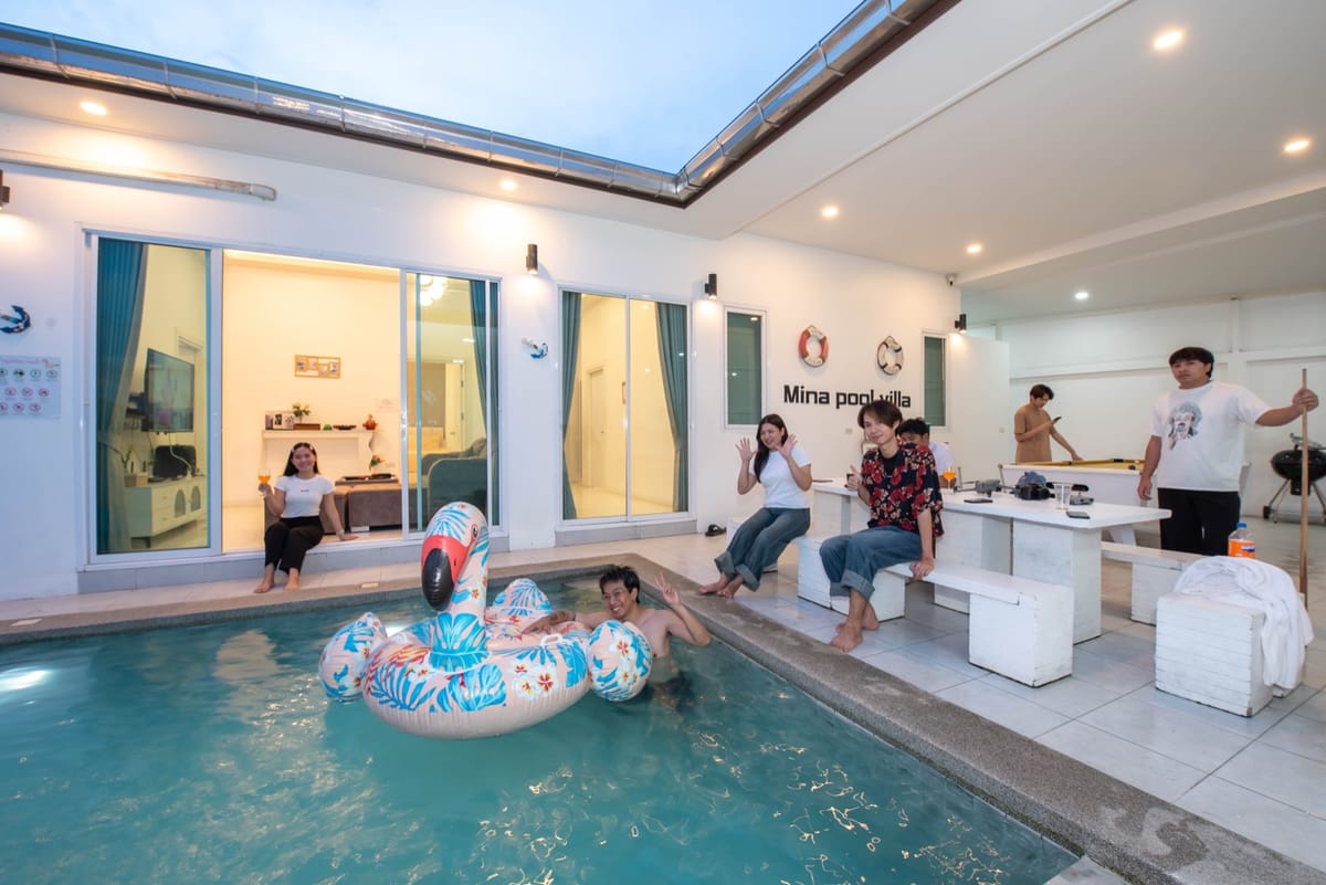 Pool, waterslide and lounge seating in the evening