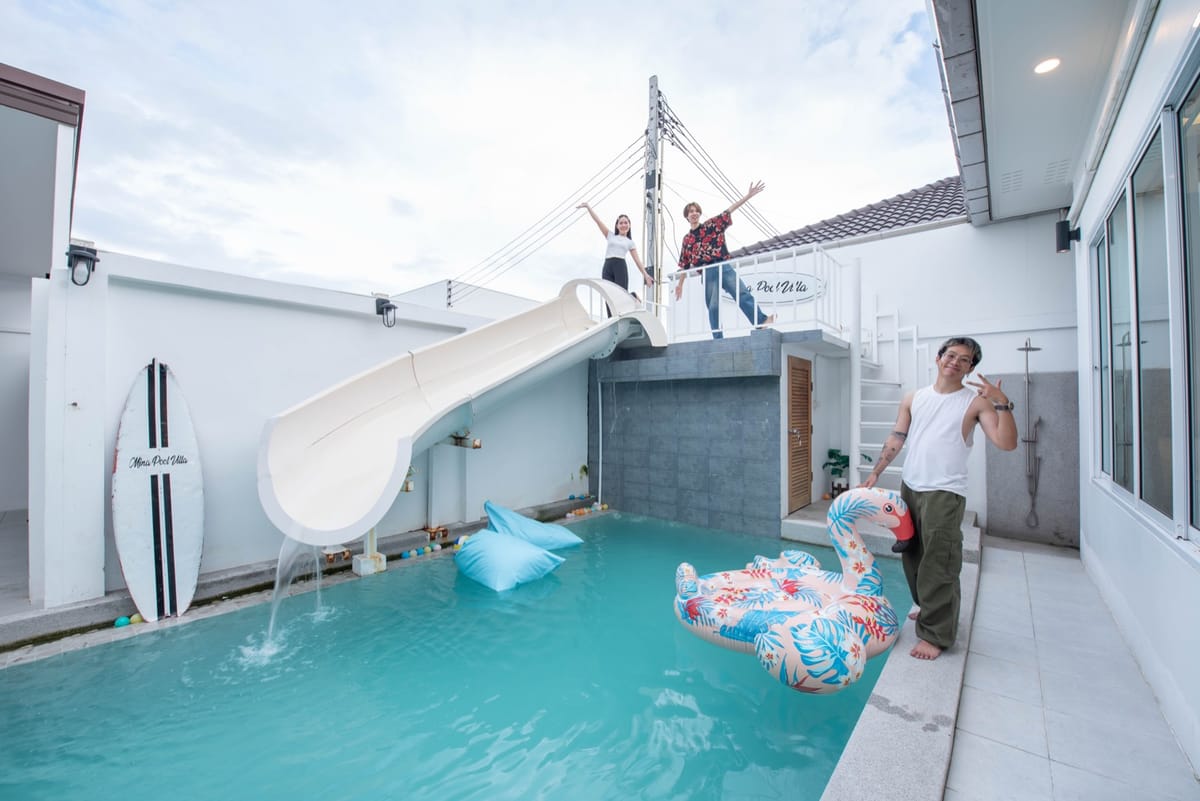 Guests using the waterslide into the private pool